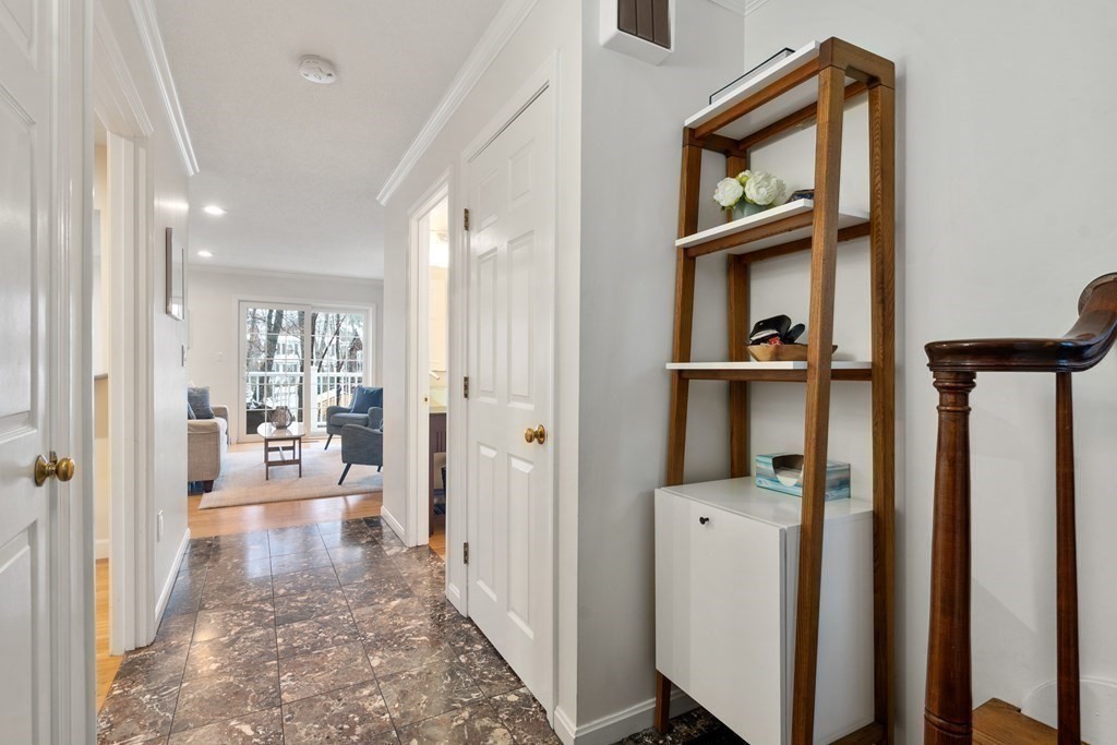 160 Pine Street, Unit 27 Newton, MA 02466 - Photo 4 of 30 a view of a hallway view with wooden floor and living room