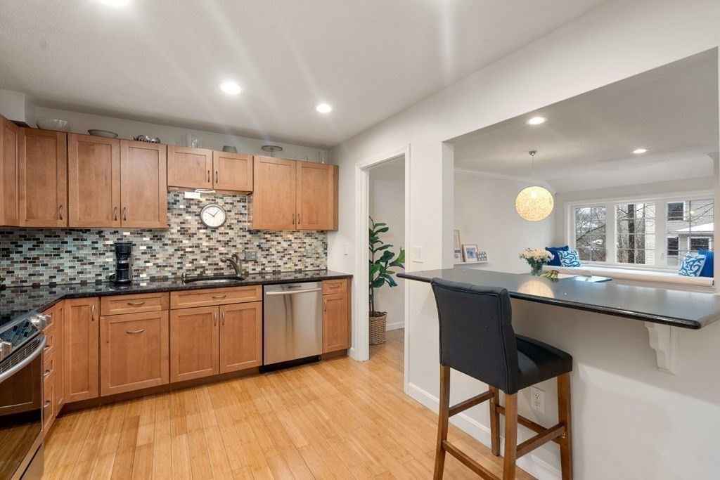 160 Pine Street, Unit 27 Newton, MA 02466 - Photo 6 of 30 a kitchen with stainless steel appliances granite countertop a sink counter space and cabinets