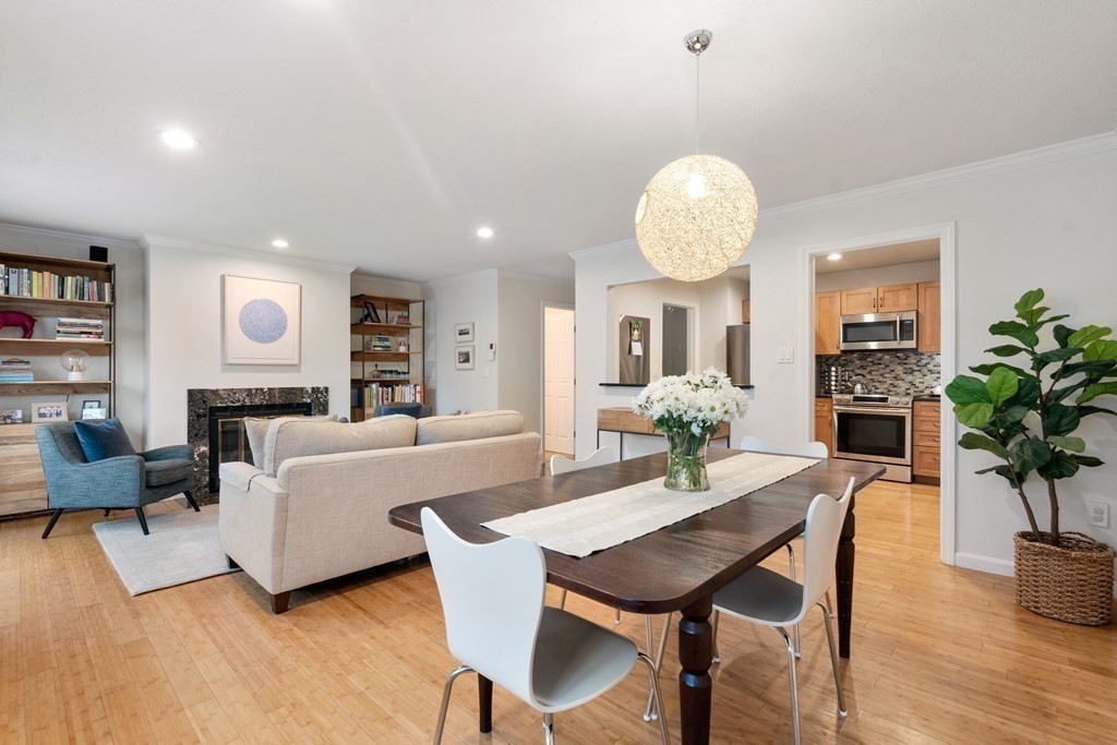 160 Pine Street, Unit 27 Newton, MA 02466 - Photo 9 of 30 a dining room with furniture potted plants and wooden floor