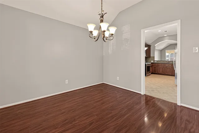 a view of a room with wooden floor and ceiling fan
