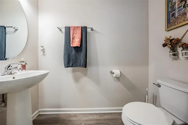 a bathroom with a sink mirror and toilet