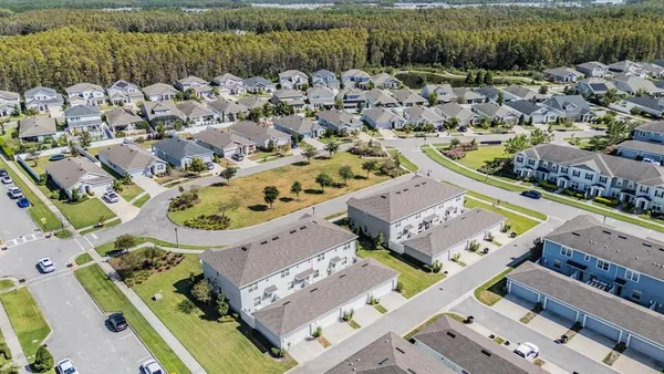 an aerial view of a house with a yard and garden