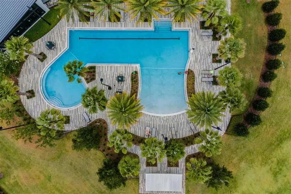 an aerial view of residential houses with outdoor space and swimming pool