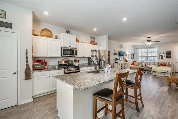 a kitchen with granite countertop lots of counter top space and wooden floor