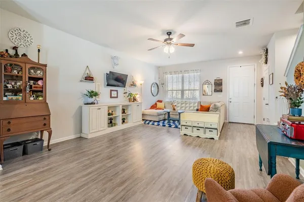 a living room with furniture and a wooden floor