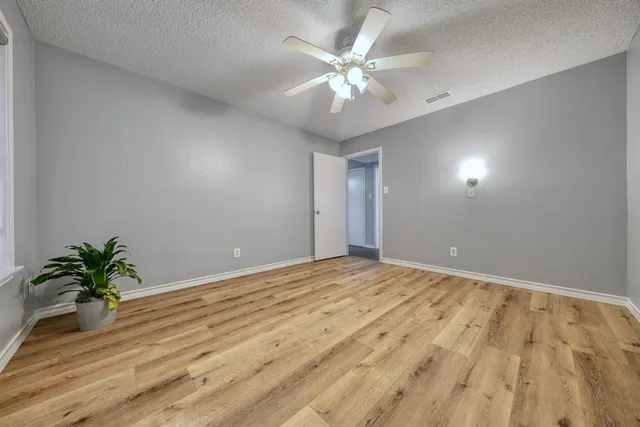 a view of an empty room and wooden floor