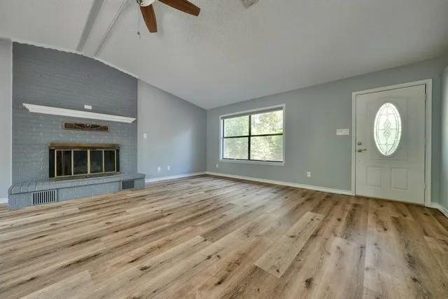 wooden floor chandelier and windows in a room