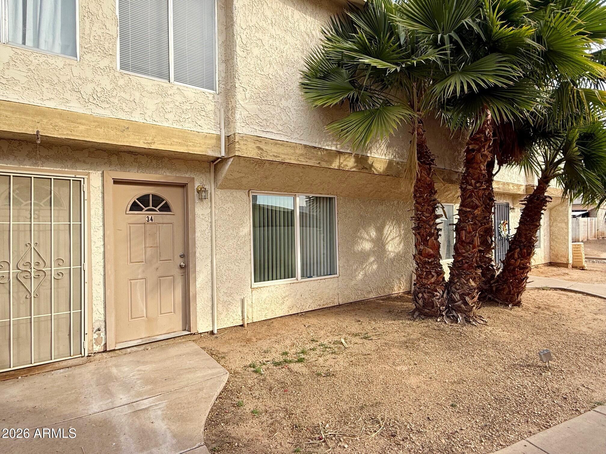 3840 North 43rd Avenue, Unit 34 Phoenix, AZ 85031 - Photo 18 of 18 a view of a house with a yard