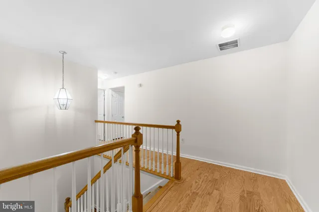 a view of hallway with wooden floor
