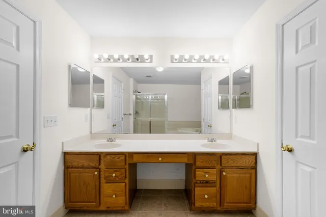 a bathroom with a double vanity sink and a mirror