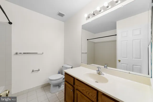 a bathroom with a sink toilet and a mirror