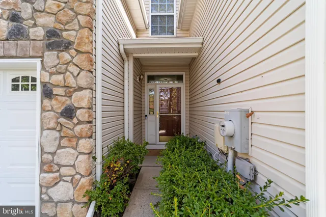 a view of a house with potted plants