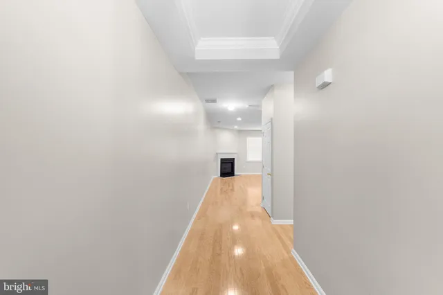 a view of hallway with wooden floor