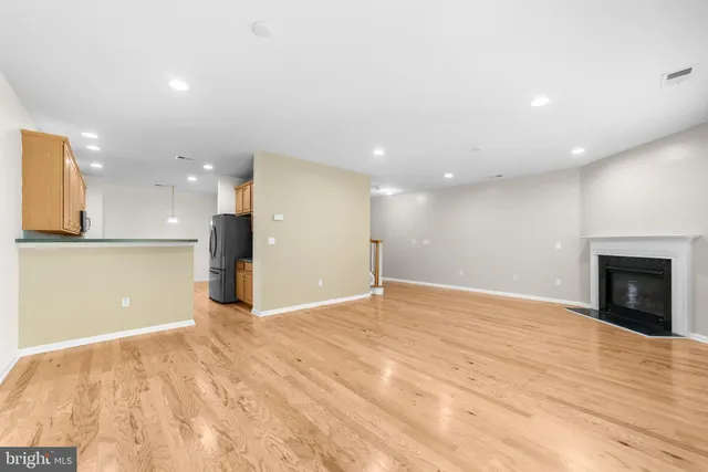 a view of an empty room with a fireplace