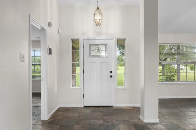 an empty room with windows mirror and windows