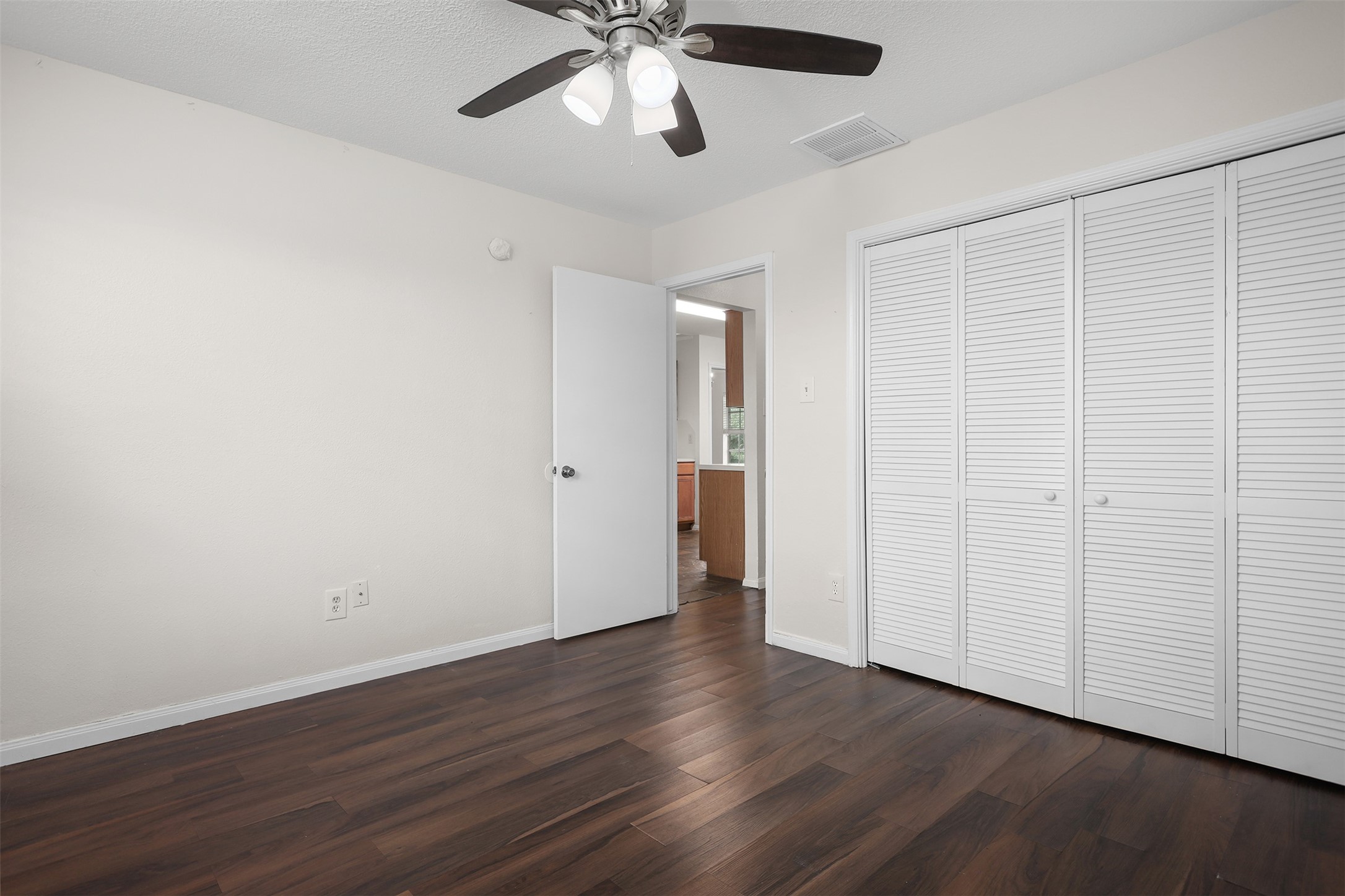 1333 Highway 36 Rosenberg, TX 77471 - Photo 22 of 40 a view of an empty room with wooden floor and a ceiling fan