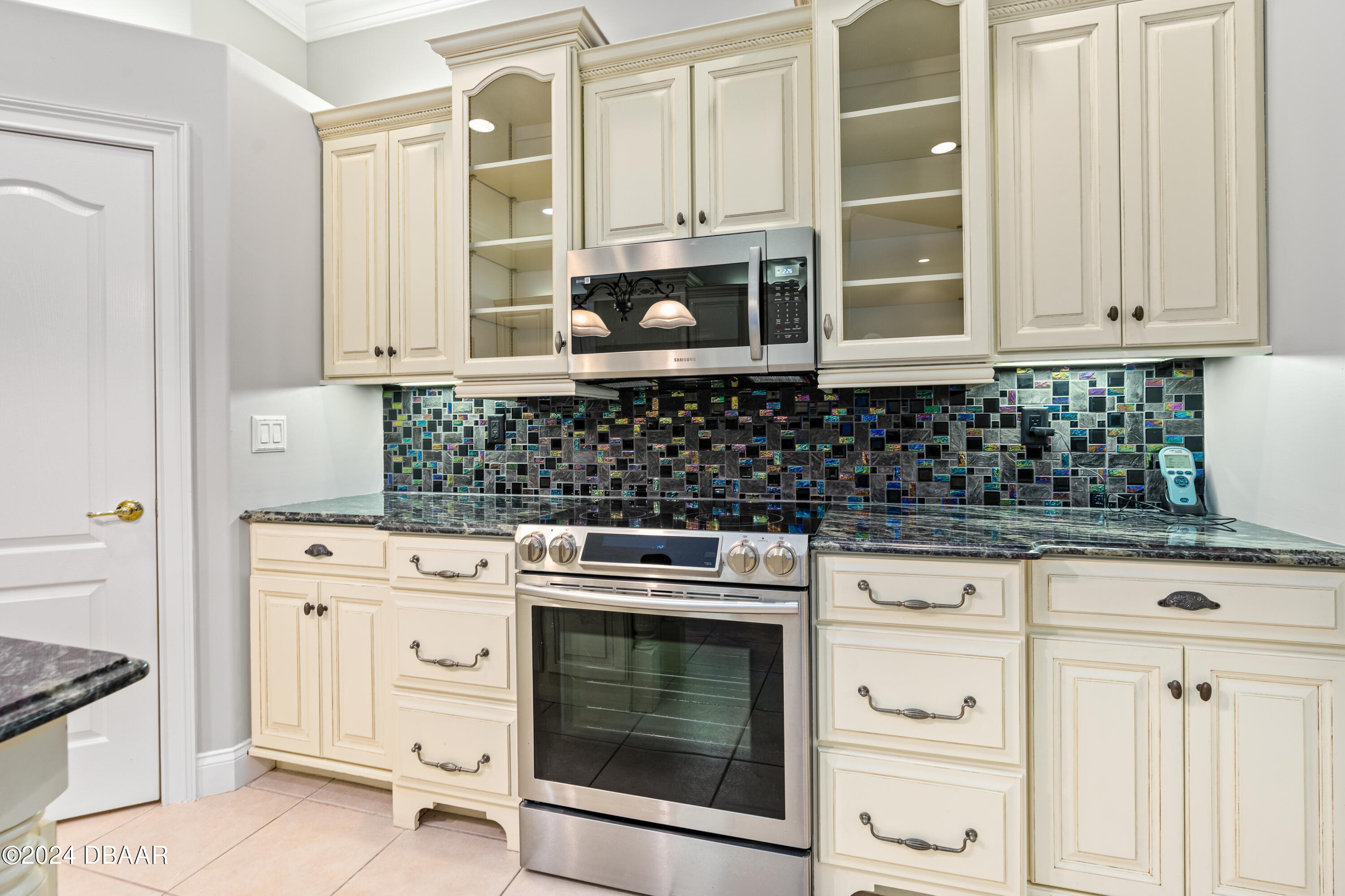 16 Foxcroft Ormond Beach Ormond Beach, FL 32174 - Photo 12 of 54 a kitchen with white cabinets and appliances