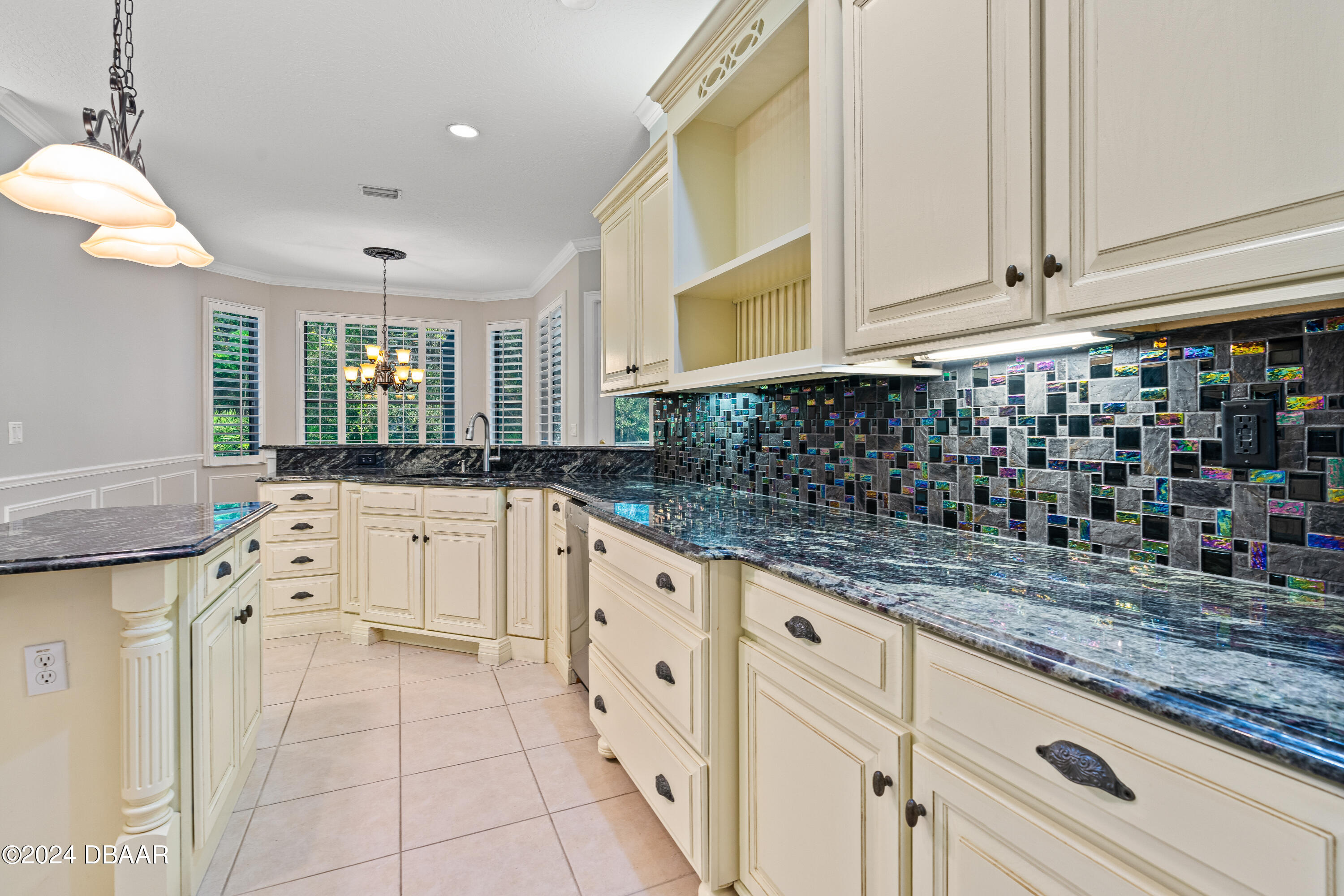 16 Foxcroft Ormond Beach Ormond Beach, FL 32174 - Photo 13 of 54 a kitchen with granite countertop white cabinets and white appliances