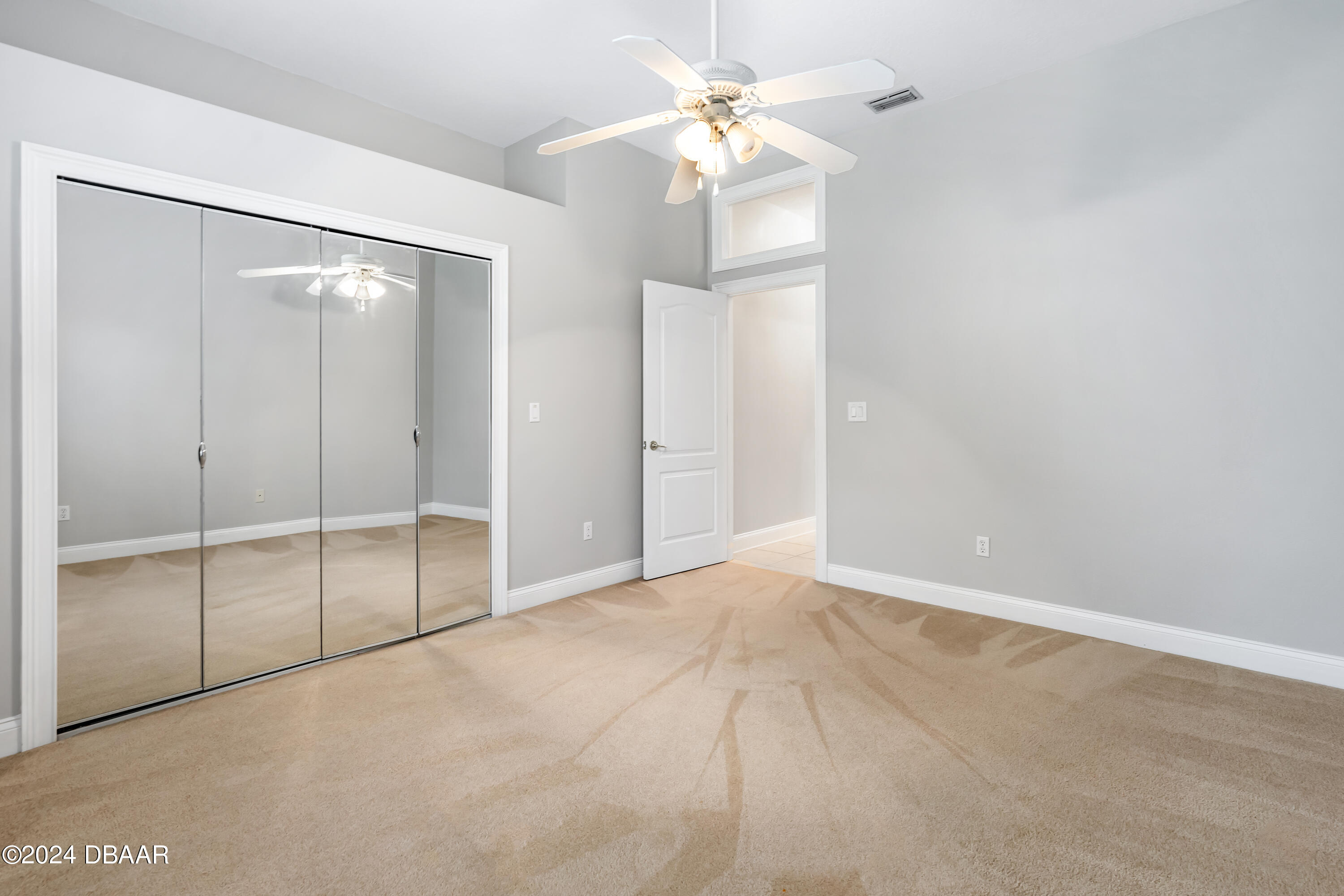 16 Foxcroft Ormond Beach Ormond Beach, FL 32174 - Photo 25 of 54 an empty room with closet and a ceiling fan