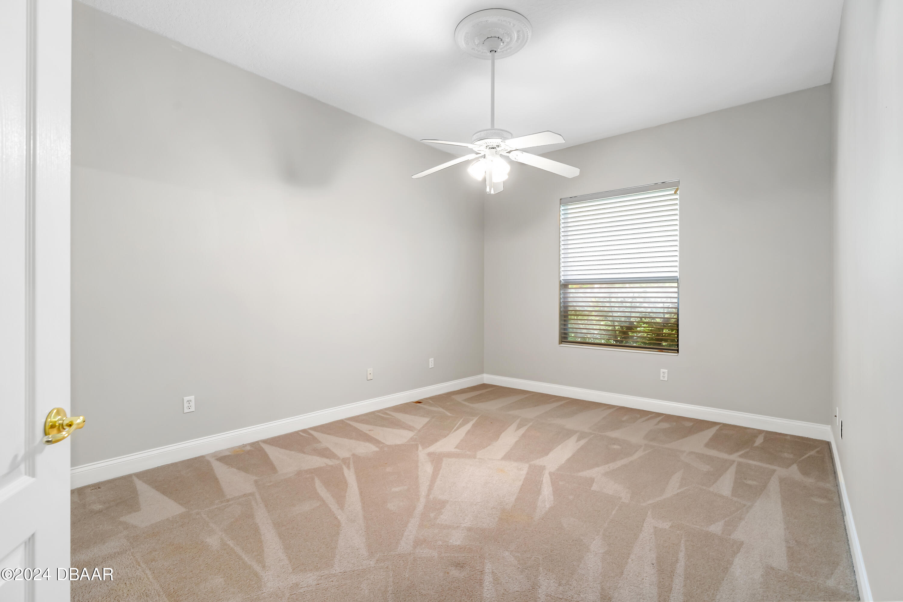 16 Foxcroft Ormond Beach Ormond Beach, FL 32174 - Photo 26 of 54 an empty room with windows and fan