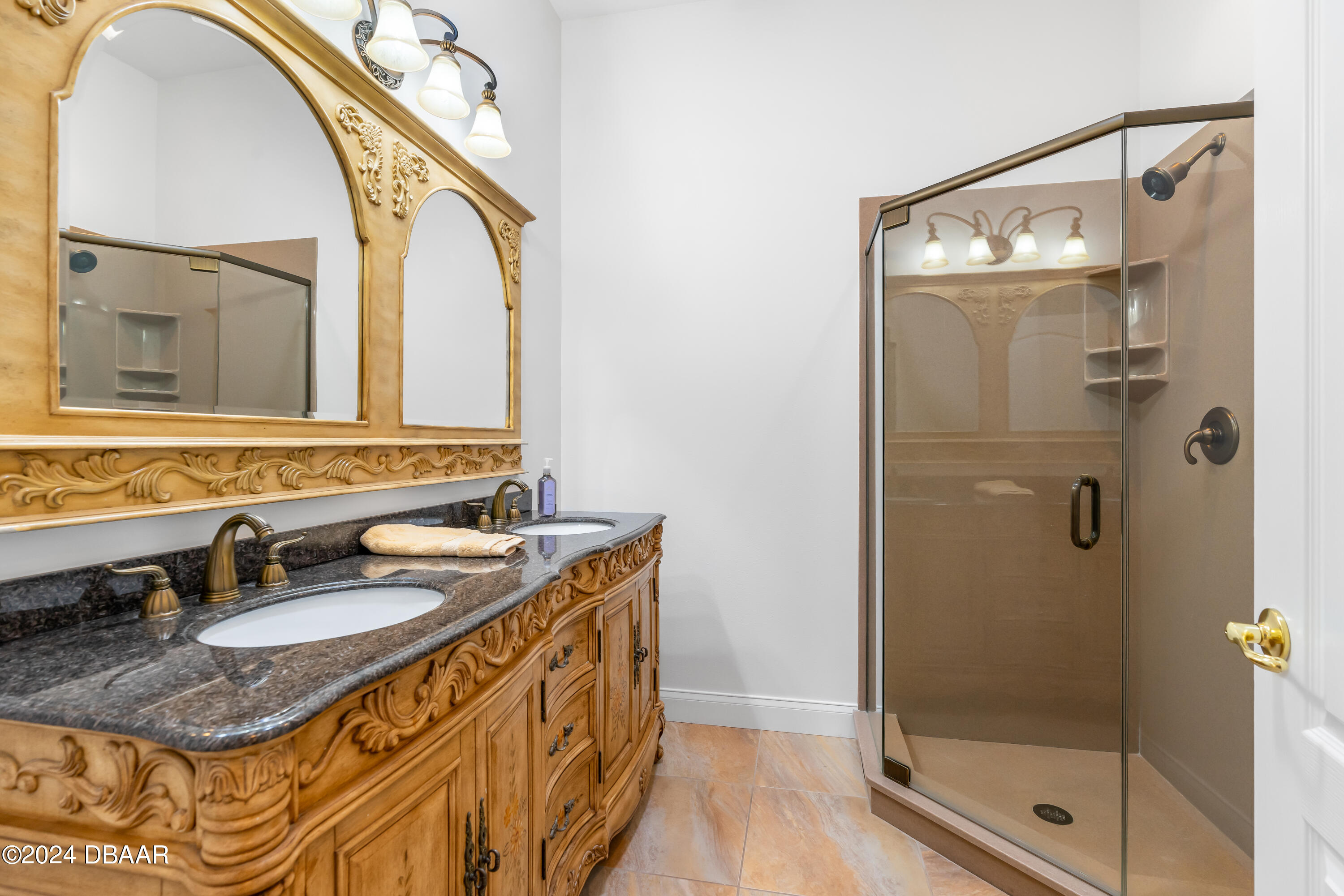 16 Foxcroft Ormond Beach Ormond Beach, FL 32174 - Photo 28 of 54 a bathroom with a granite countertop shower a sink and a mirror