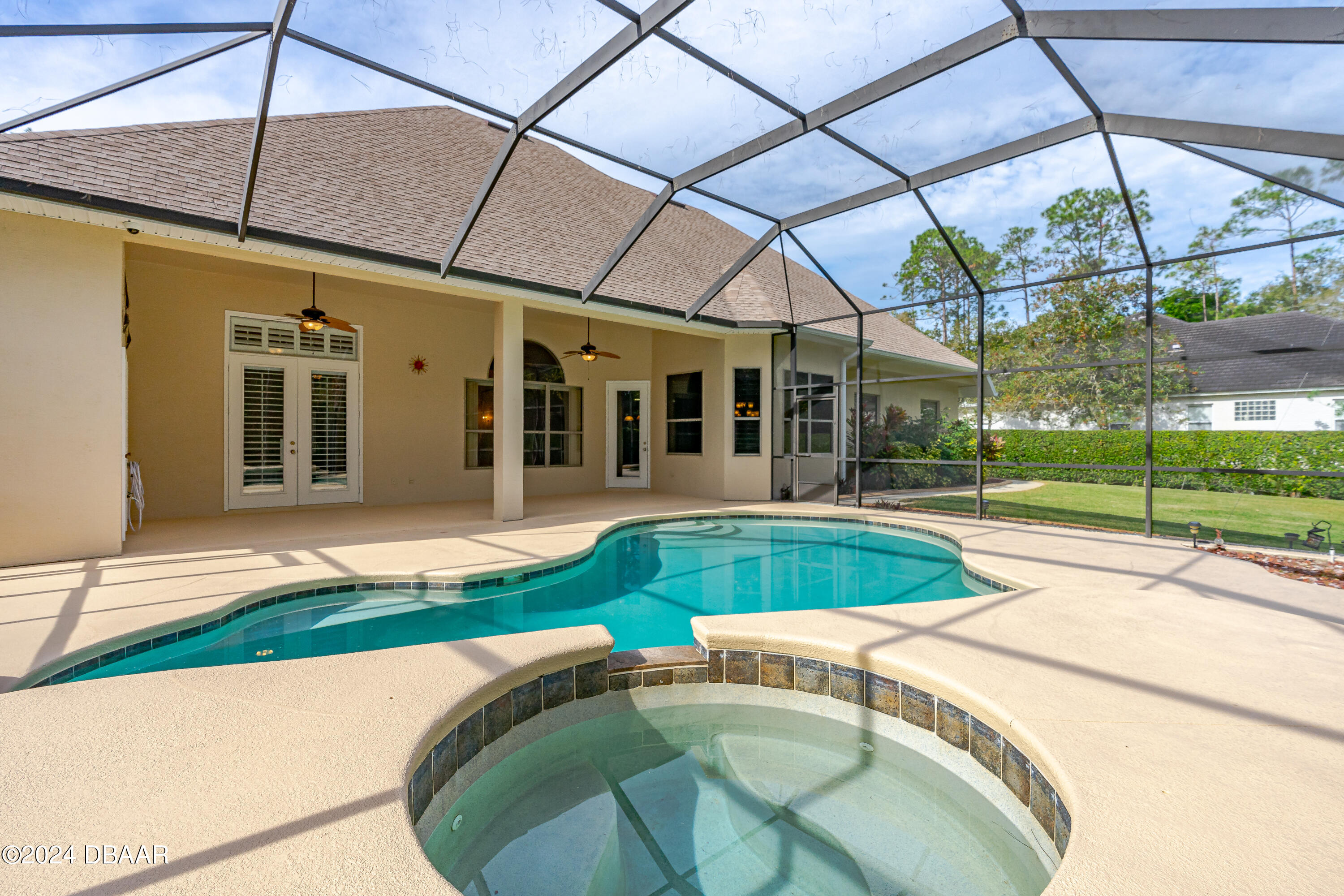16 Foxcroft Ormond Beach Ormond Beach, FL 32174 - Photo 33 of 54 a view of a patio with a table and chairs under an umbrella