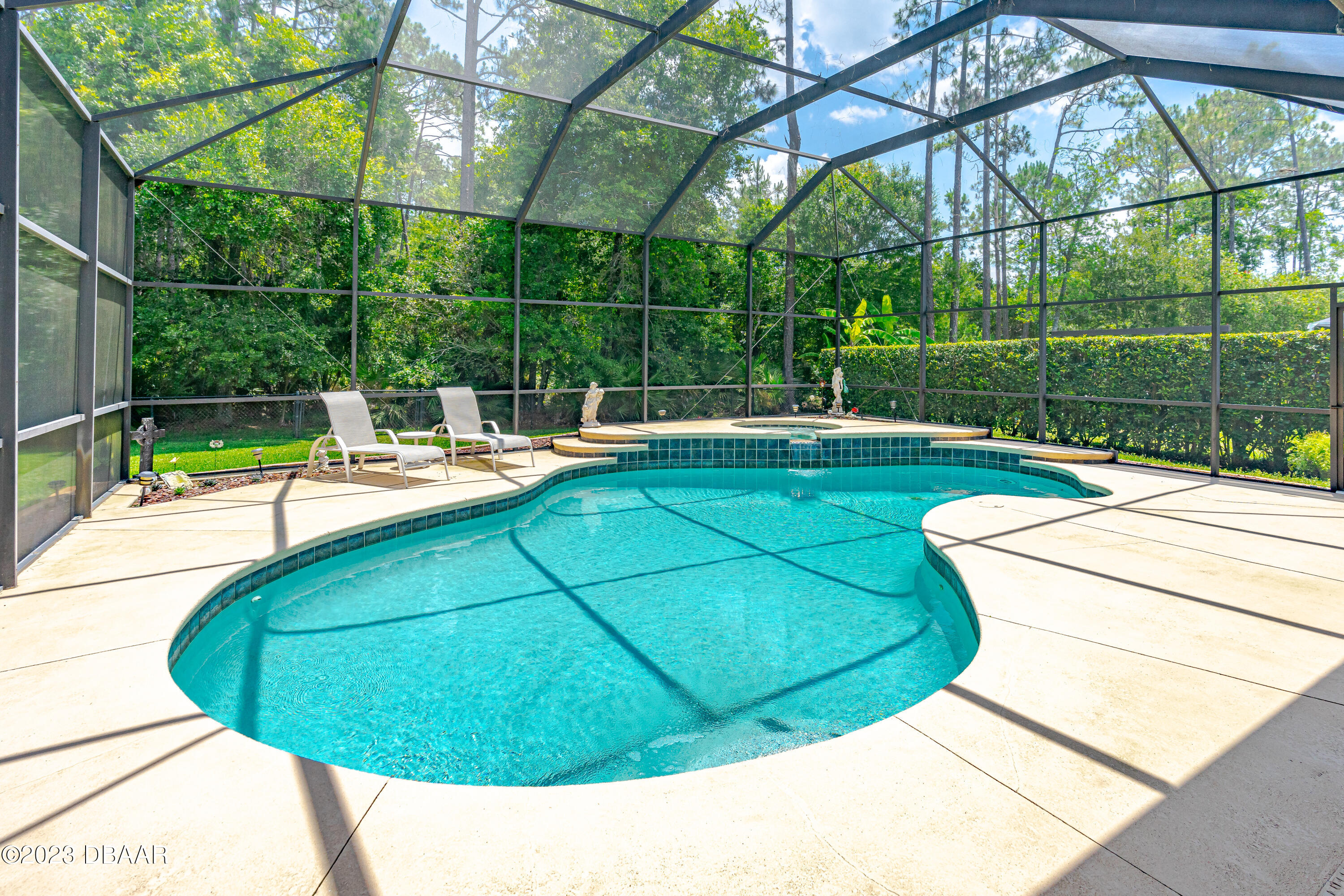 16 Foxcroft Ormond Beach Ormond Beach, FL 32174 - Photo 37 of 54 a view of a swimming pool with a yard and sitting area