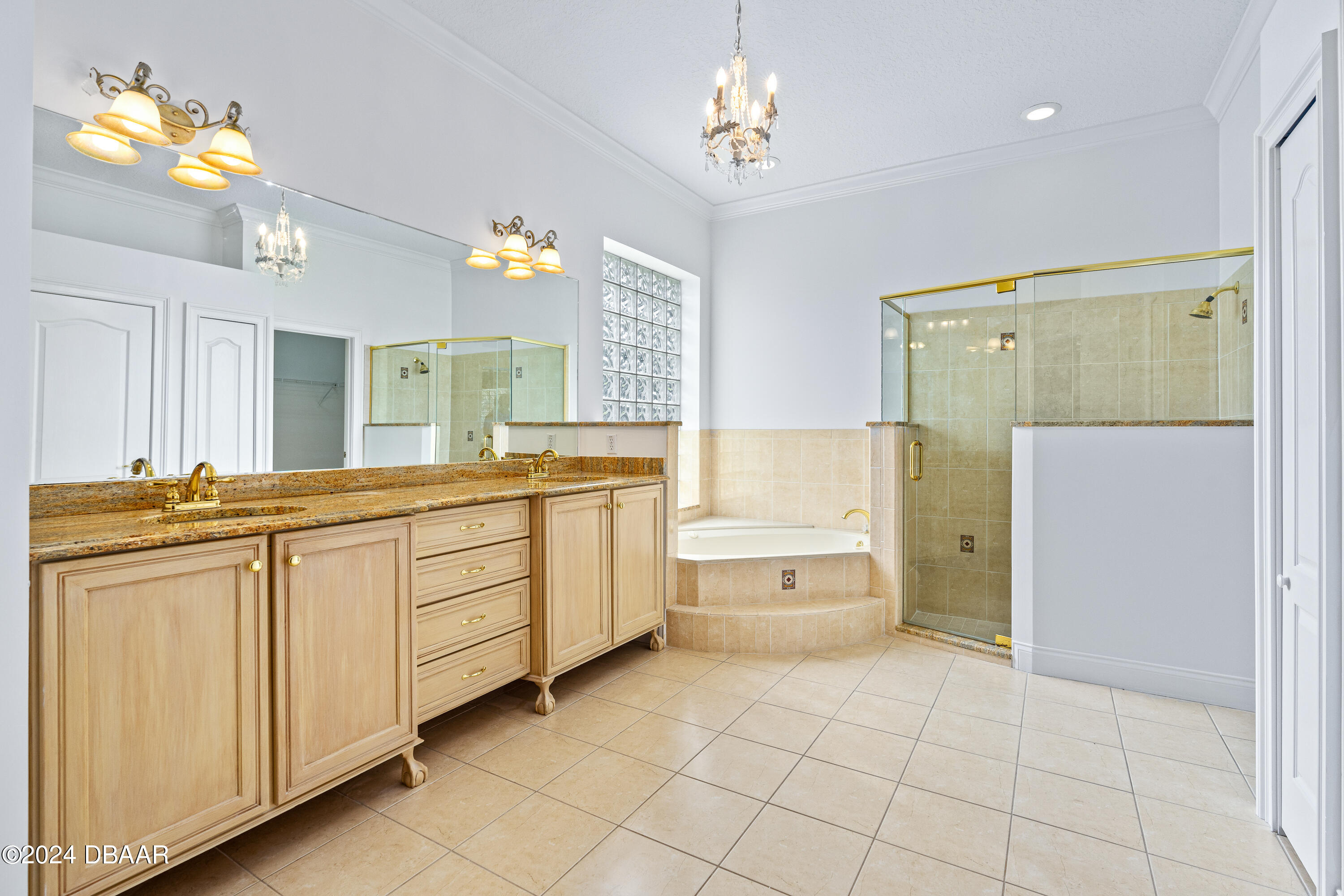 16 Foxcroft Ormond Beach Ormond Beach, FL 32174 - Photo 4 of 54 a spacious bathroom with a double vanity sink a mirror and a bathtub