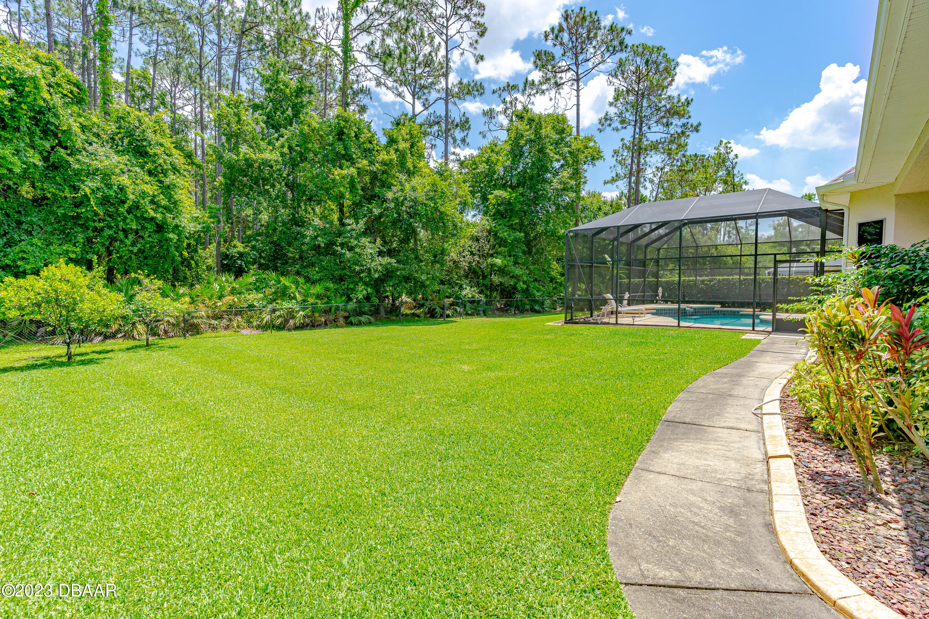 16 Foxcroft Ormond Beach Ormond Beach, FL 32174 - Photo 41 of 54 a view of a patio with a table and chairs under an umbrella
