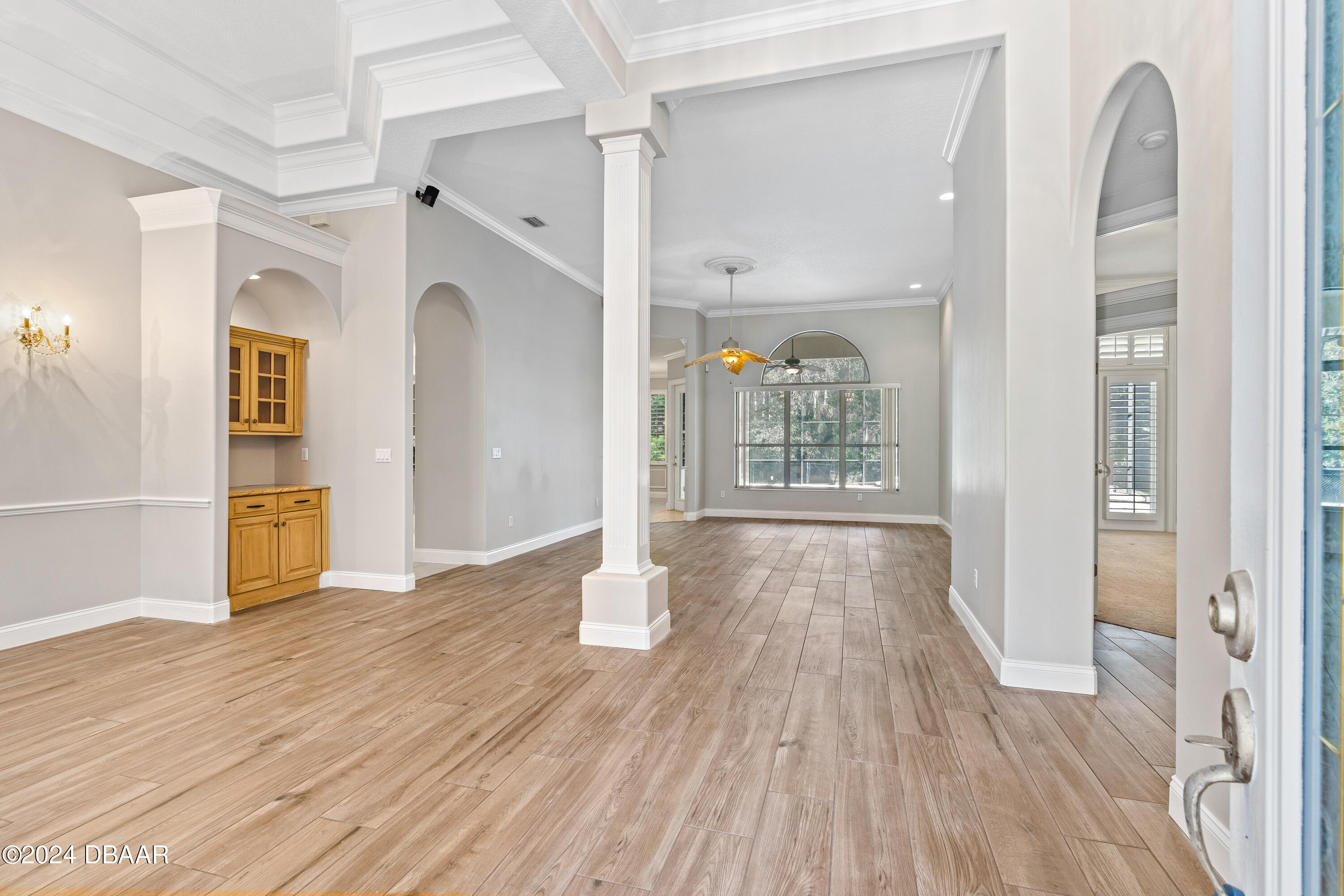 16 Foxcroft Ormond Beach Ormond Beach, FL 32174 - Photo 5 of 54 a view of a hallway with wooden floor and a living room