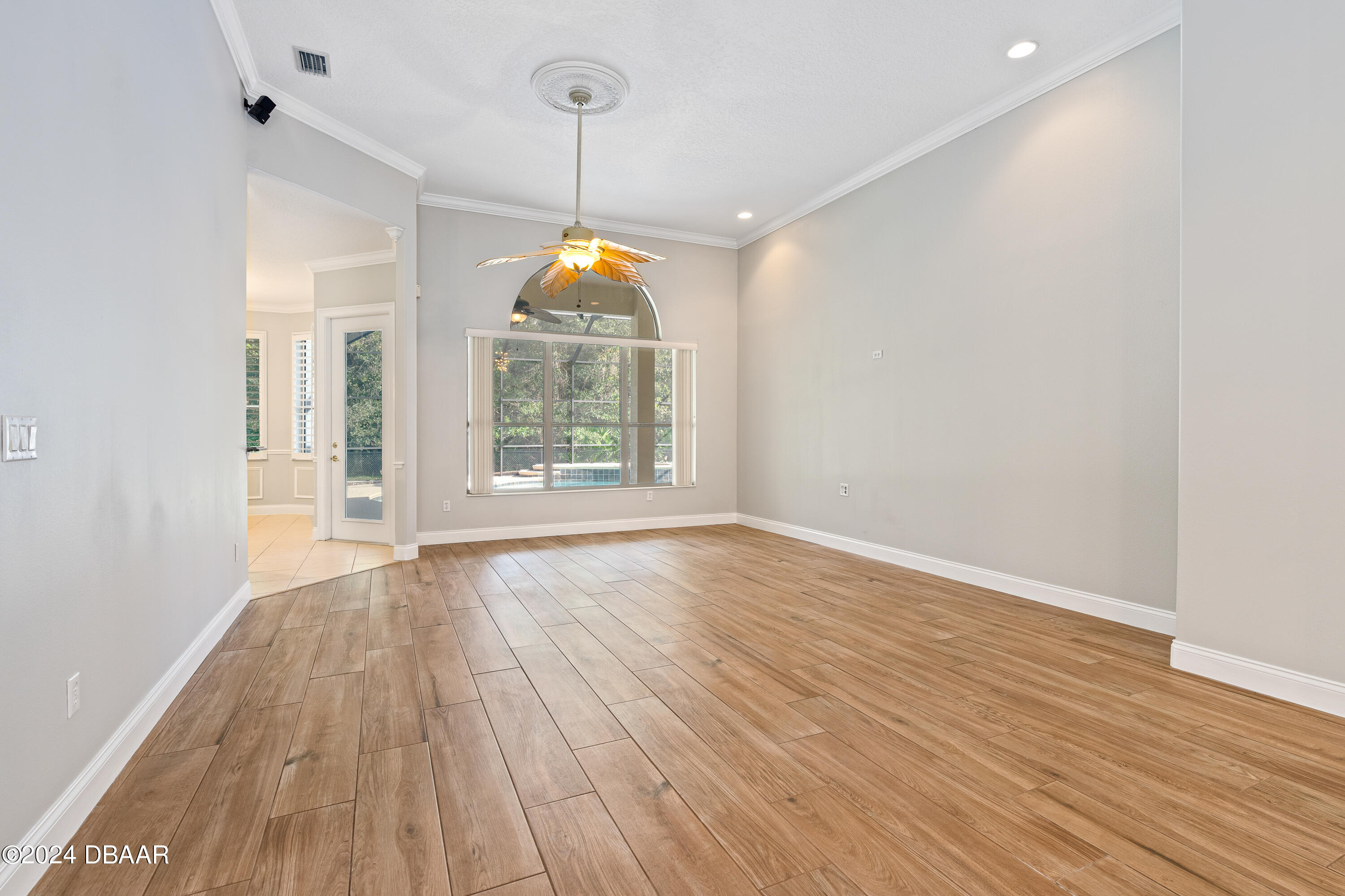 16 Foxcroft Ormond Beach Ormond Beach, FL 32174 - Photo 7 of 54 an empty room with wooden floor and windows