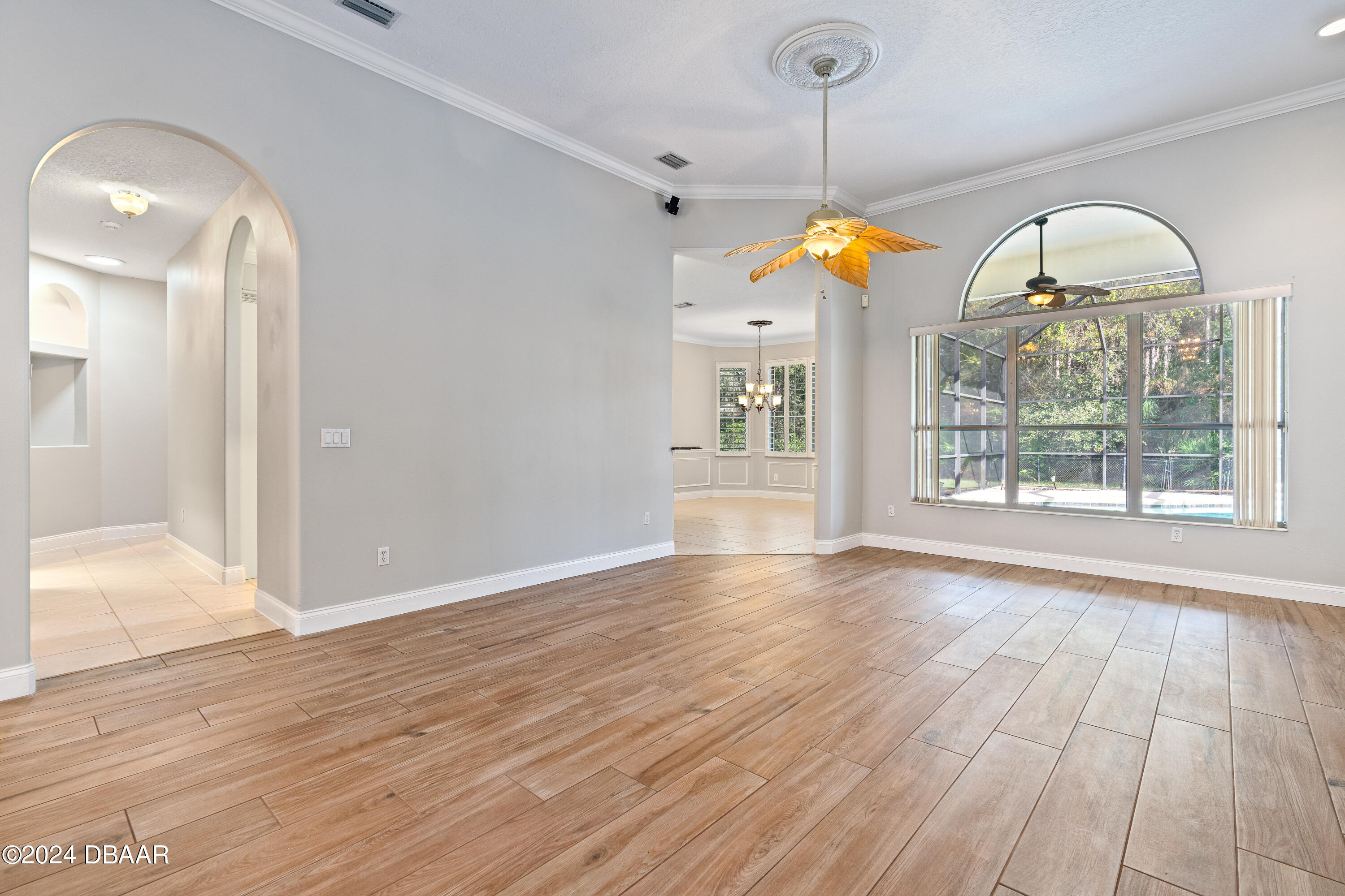16 Foxcroft Ormond Beach Ormond Beach, FL 32174 - Photo 10 of 54 a view of an empty room with wooden floor and a window