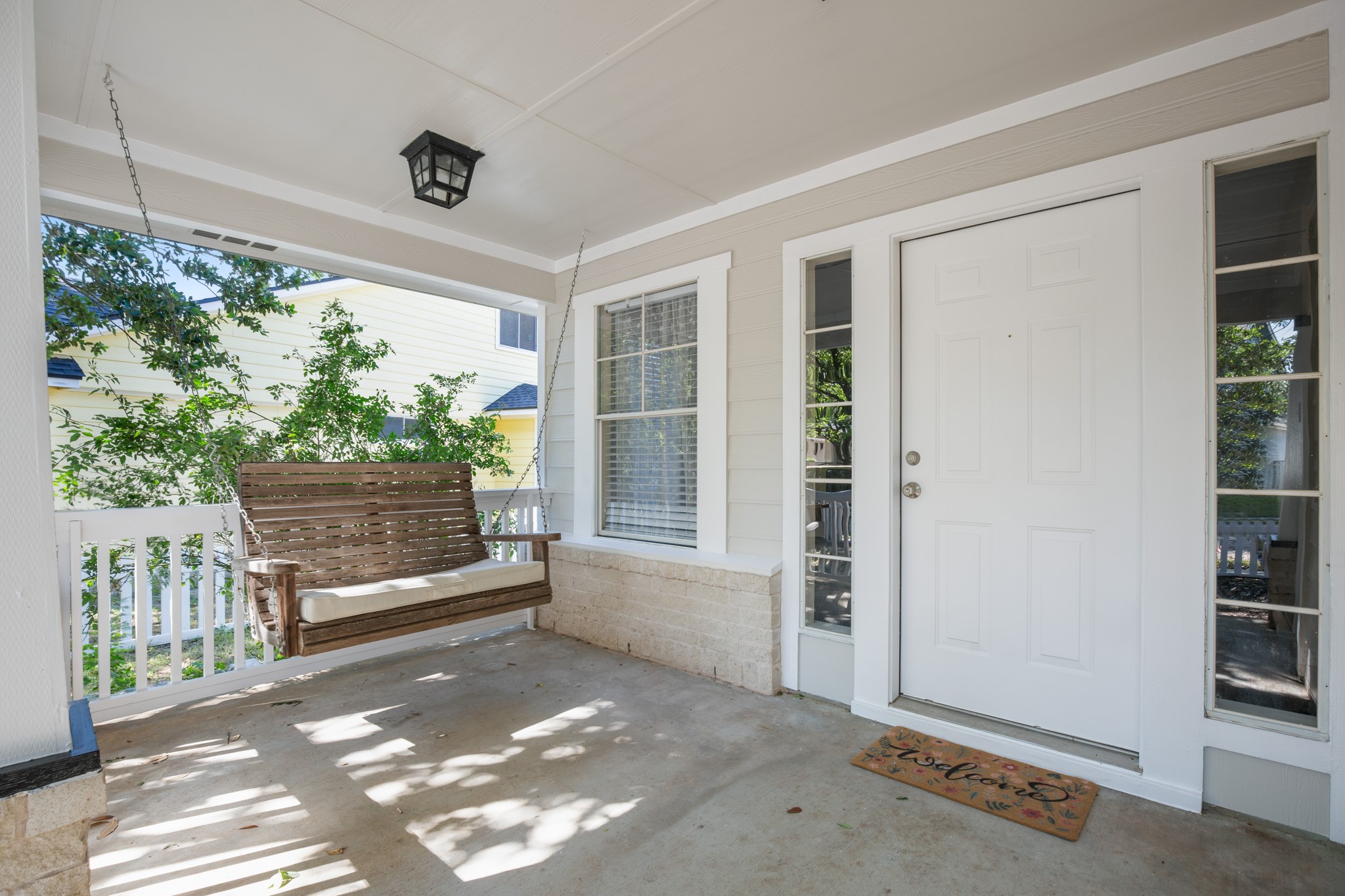 151 Sampson Kyle, TX 78640 - Photo 14 of 23 A shaded front porch with a swing sets the tone immediately, welcoming, relaxed, and made for slow mornings and evening conversations beneath the trees.