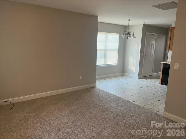 an empty room with windows and bathroom