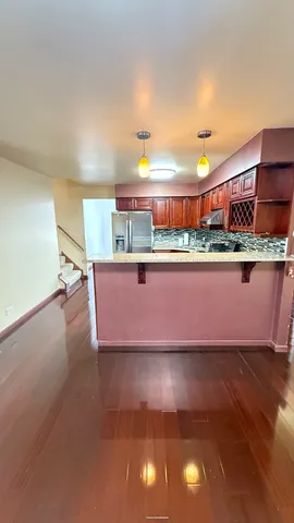 a view of a room with wooden floor