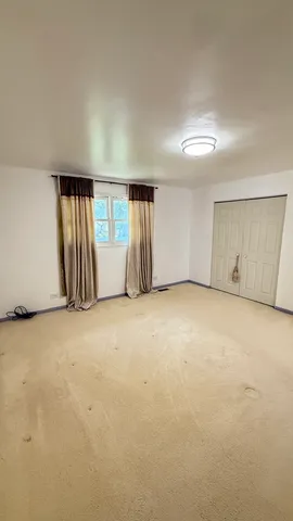 an empty room with a empty space and windows