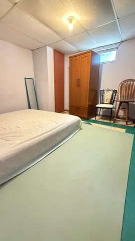 a bedroom with a bed and a view of kitchen