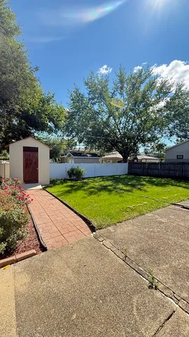 a view of a house with a yard and a garden