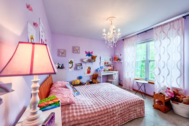 a bedroom with a bed and a chandelier