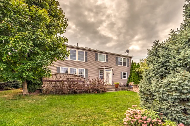 a front view of a house with garden