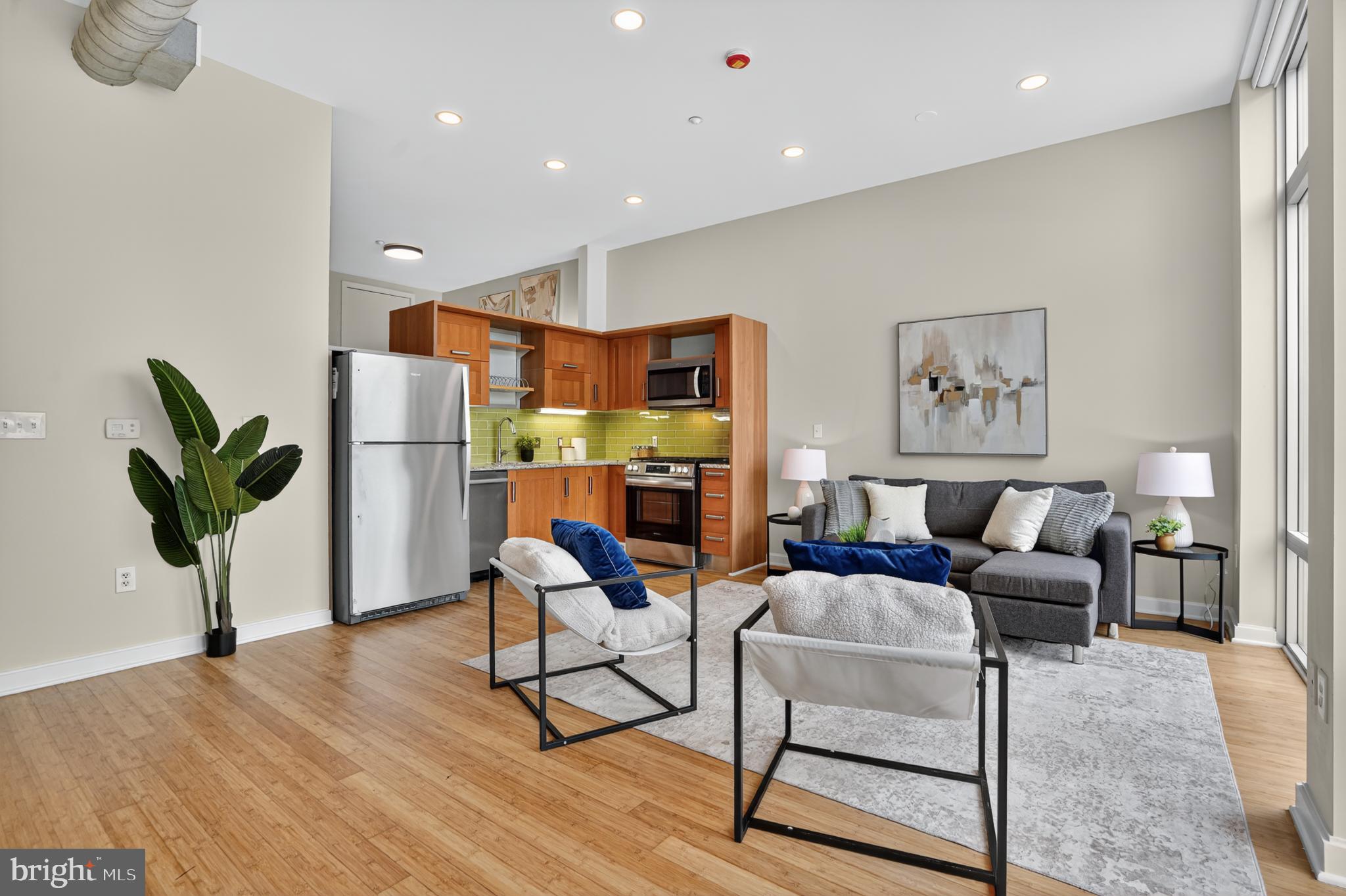 1390 V Street Northwest, Unit 306 Washington, DC 20009 - Photo 14 of 19 a living room with furniture a wooden floor and a potted plant