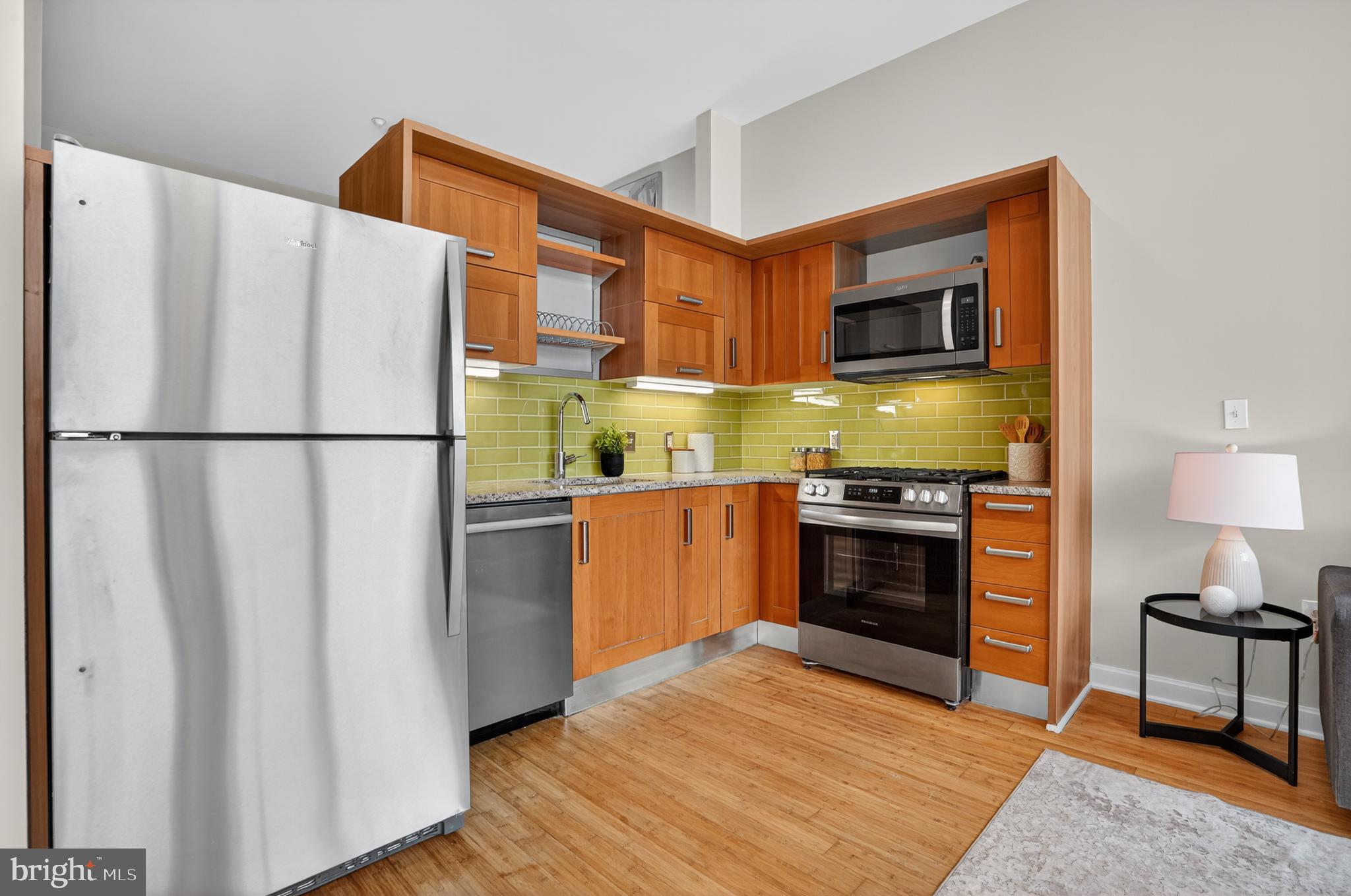 1390 V Street Northwest, Unit 306 Washington, DC 20009 - Photo 18 of 19 a kitchen with stainless steel appliances a refrigerator stove and microwave