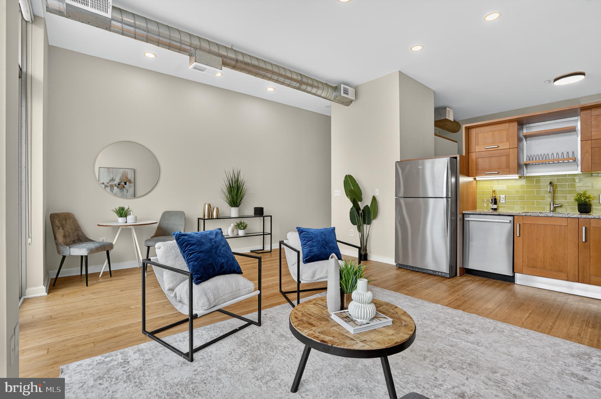 1390 V Street Northwest, Unit 306 Washington, DC 20009 - Photo 2 of 19 a living room with furniture and a kitchen