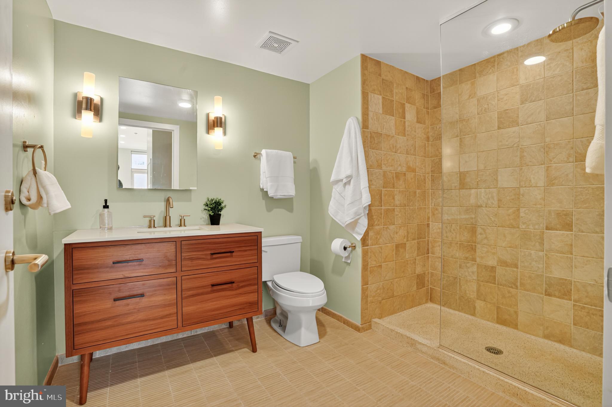 1390 V Street Northwest, Unit 306 Washington, DC 20009 - Photo 6 of 19 a bathroom with a shower sink vanity mirror and toilet