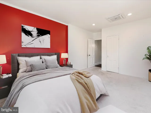 a bedroom with bed and wall painting