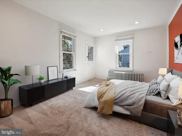 a bedroom with a bed and window