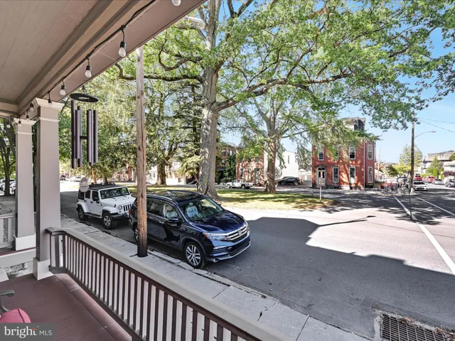a view of a swimming pool with a patio and a yard