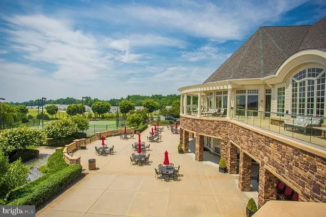a view of a house with pool and chairs
