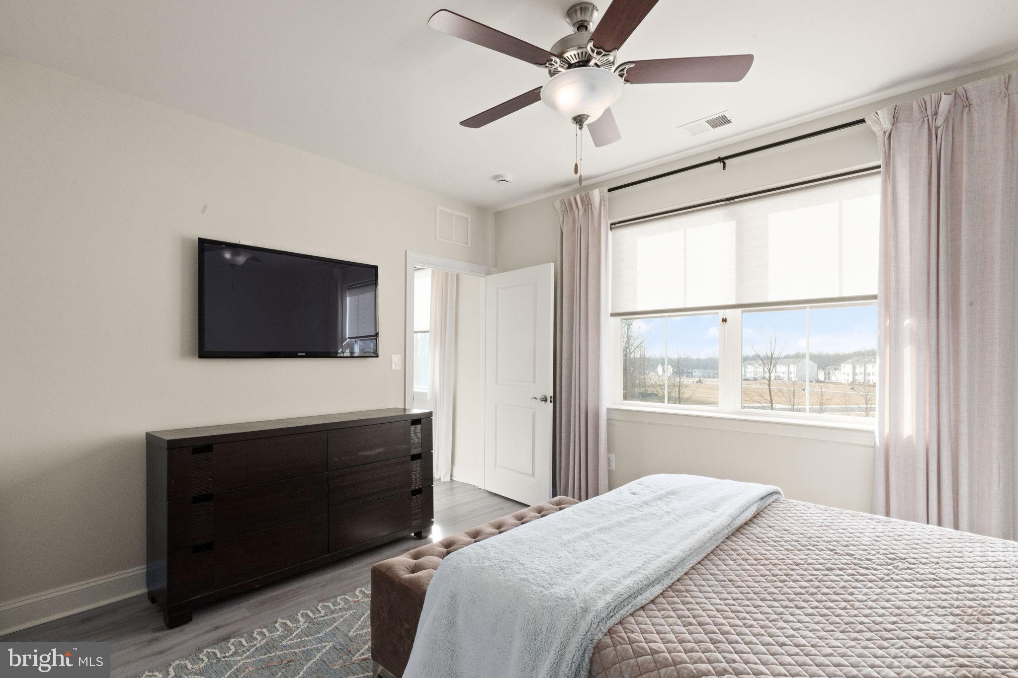 406 Bold Ruler Court, Unit 207 Havre de Grace, MD 21078 - Photo 13 of 57 a bedroom with a bed and a flat screen tv