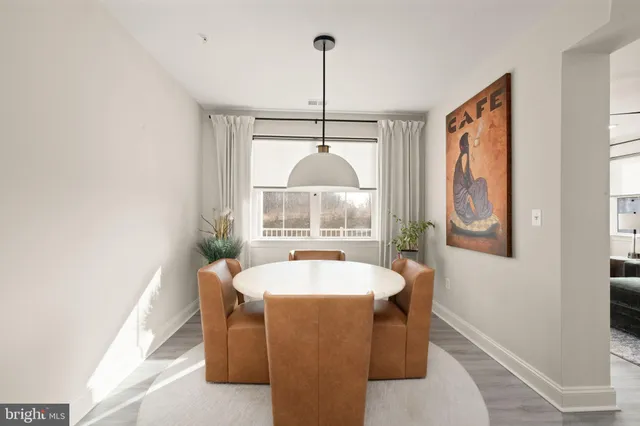 a dining room with a window and chandelier